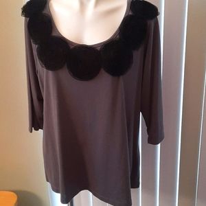 Black floral accents around the neckline top